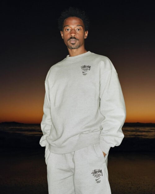 Man wearing relaxed grey Stussy sweatshirt and matching joggers