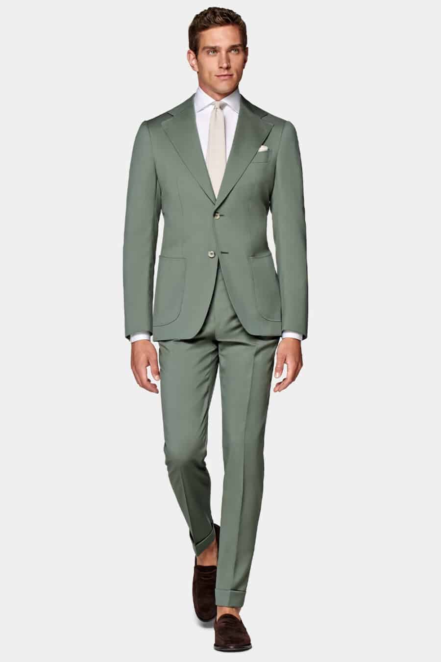 Men's light green suit, white dress shirt, off-white tie and dark brown suede penny loafers outfit