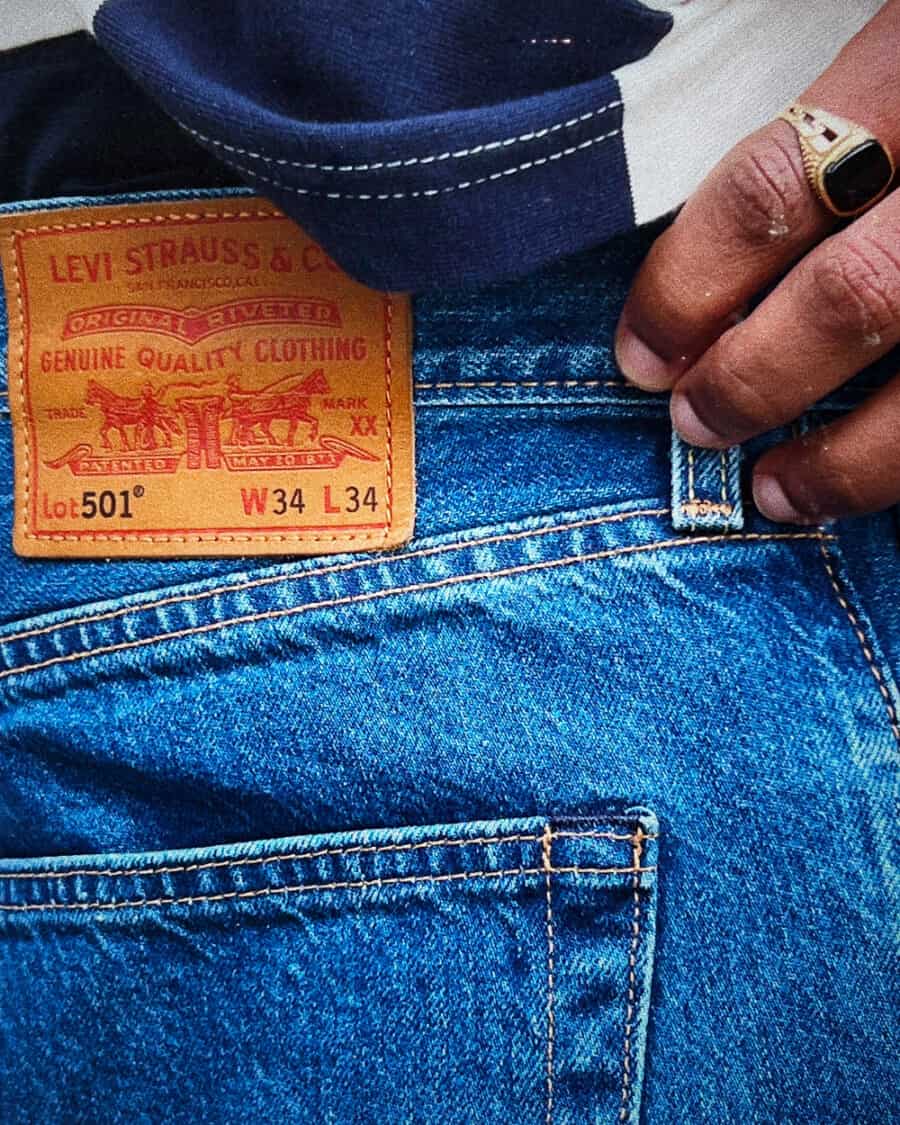 Back pocket and label of a pair of budget, mid-wash Levi’s 501 jeans for men