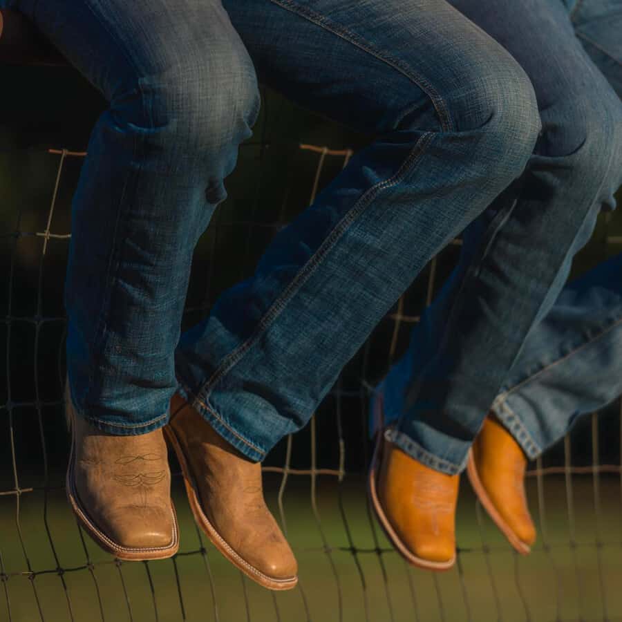 Two men wearing US-made Anderson Bean cowboy boots with mid wash denim jeans 