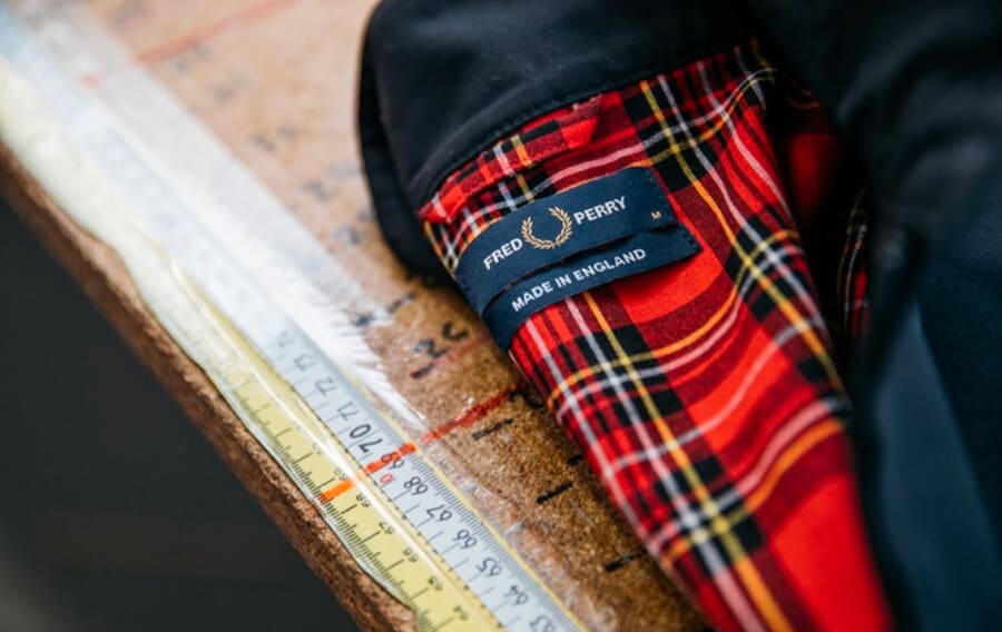 Close up of the Made in England label on a tartan lined Fred Perry Harrington jacket