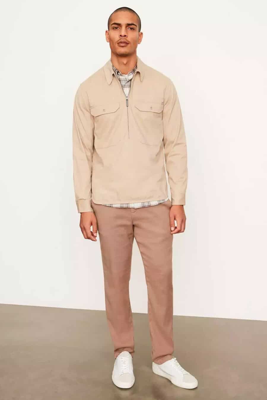 Men's brown chinos, white check shirt, cream popover shirt and white sneakers outfit