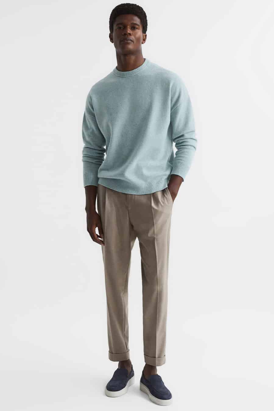 Men's light brown pants, light blue sweater and navy suede loafers outfit