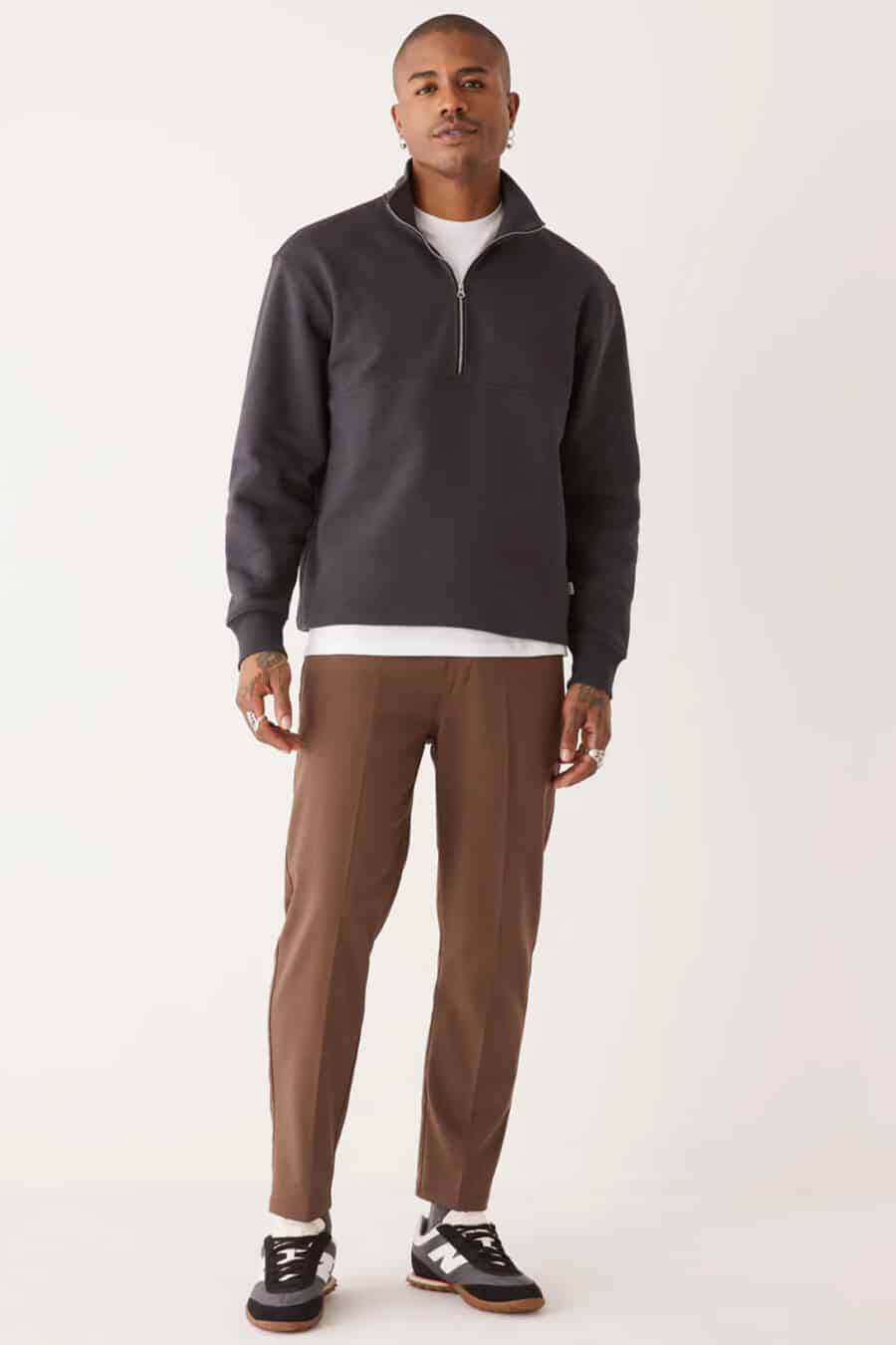Men's brown pants, white T-shirt, charcoal zip-neck sweater and New Balance running sneakers outfit