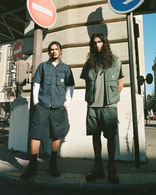 Two men wearing Carhartt WIP shorts, T-shirts, work shirt and pocket vest