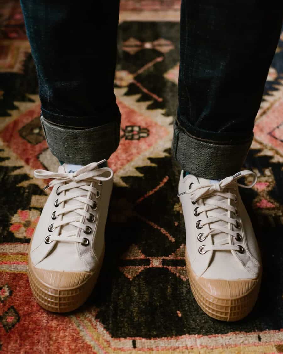 Men's affordable Novesta Star Master sneakers worn on feet with raw denim jeans