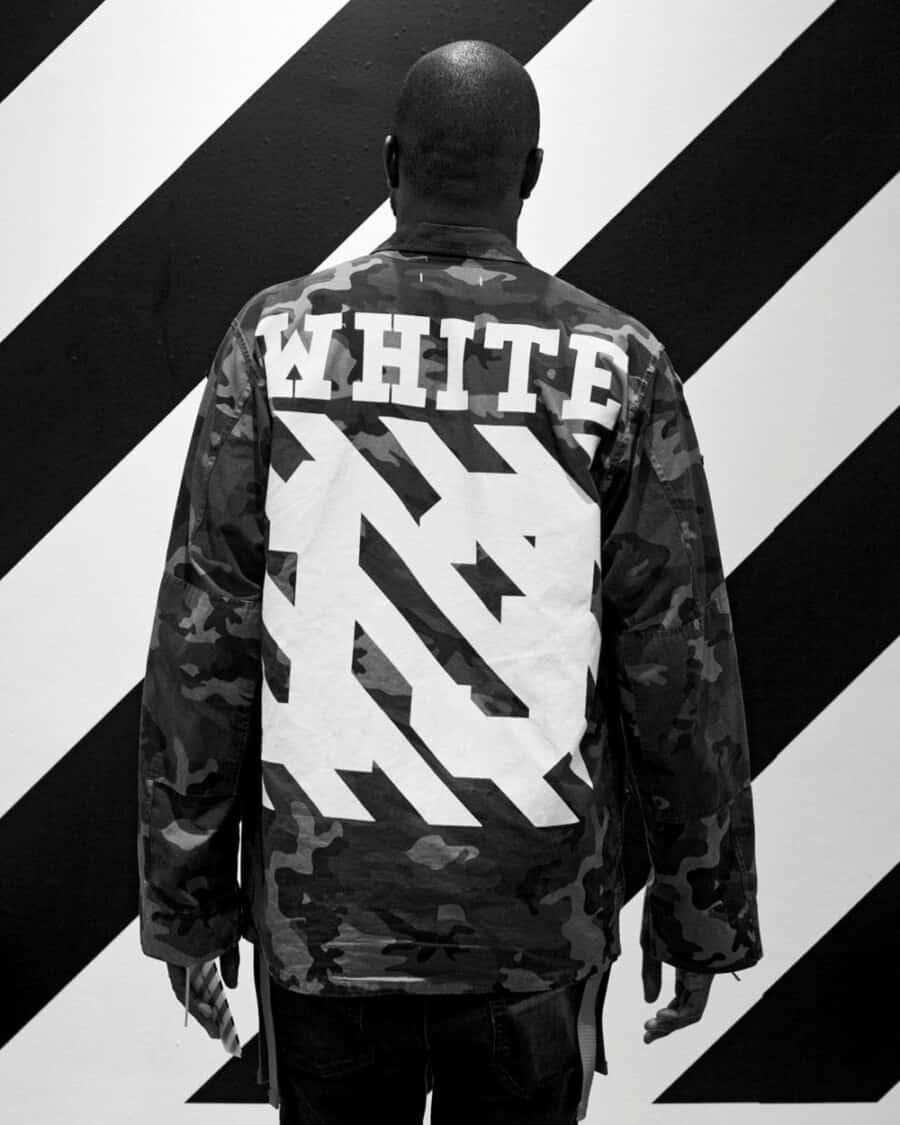 Virgil Abloh wearing a branded Off-White printed jacket