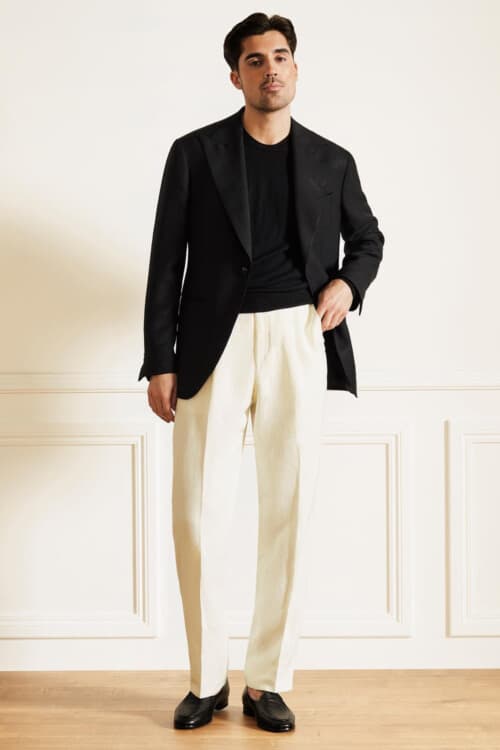 Men's luxury cream pants, black T-shirt, black blazer and black loafers outfit