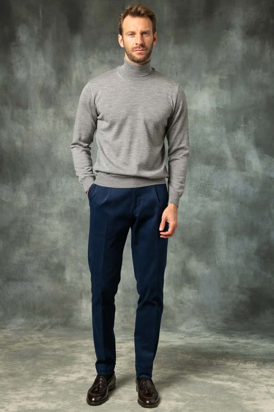 Men's navy pleated trousers, grey turtleneck and shiny tassel loafers outfit