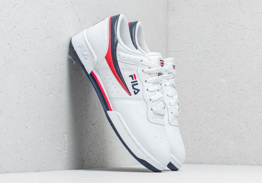 Fila Original Fitness Classic Sneaker in white, red and blue leant against wall