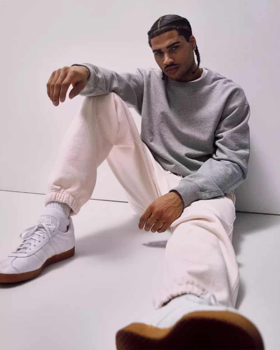 Man wearing Reigning Champ heavyweight fleece sweatpants and sweatshirt with white sneakers