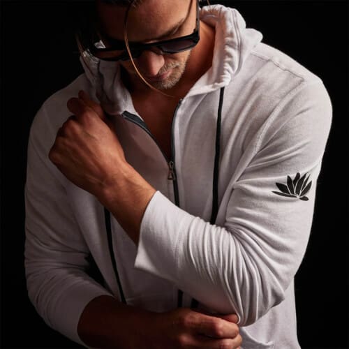 Close up of a man wearing a zip through white James Perse hoodie