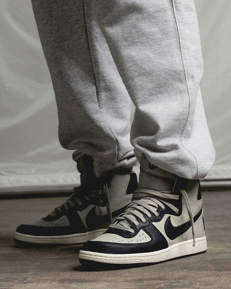 Nike Terminator Georgetown sneakers on feet worn with grey sweatpants