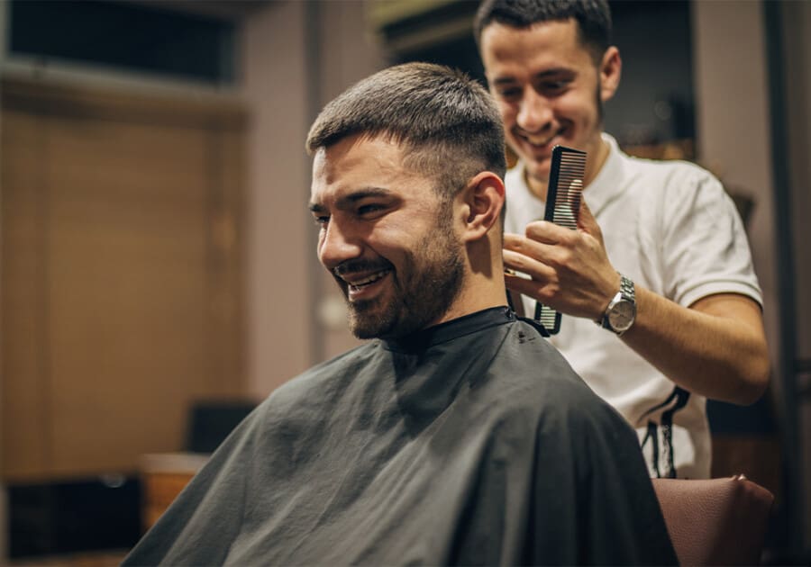 Barber cutting a short back and sides haircut on a man