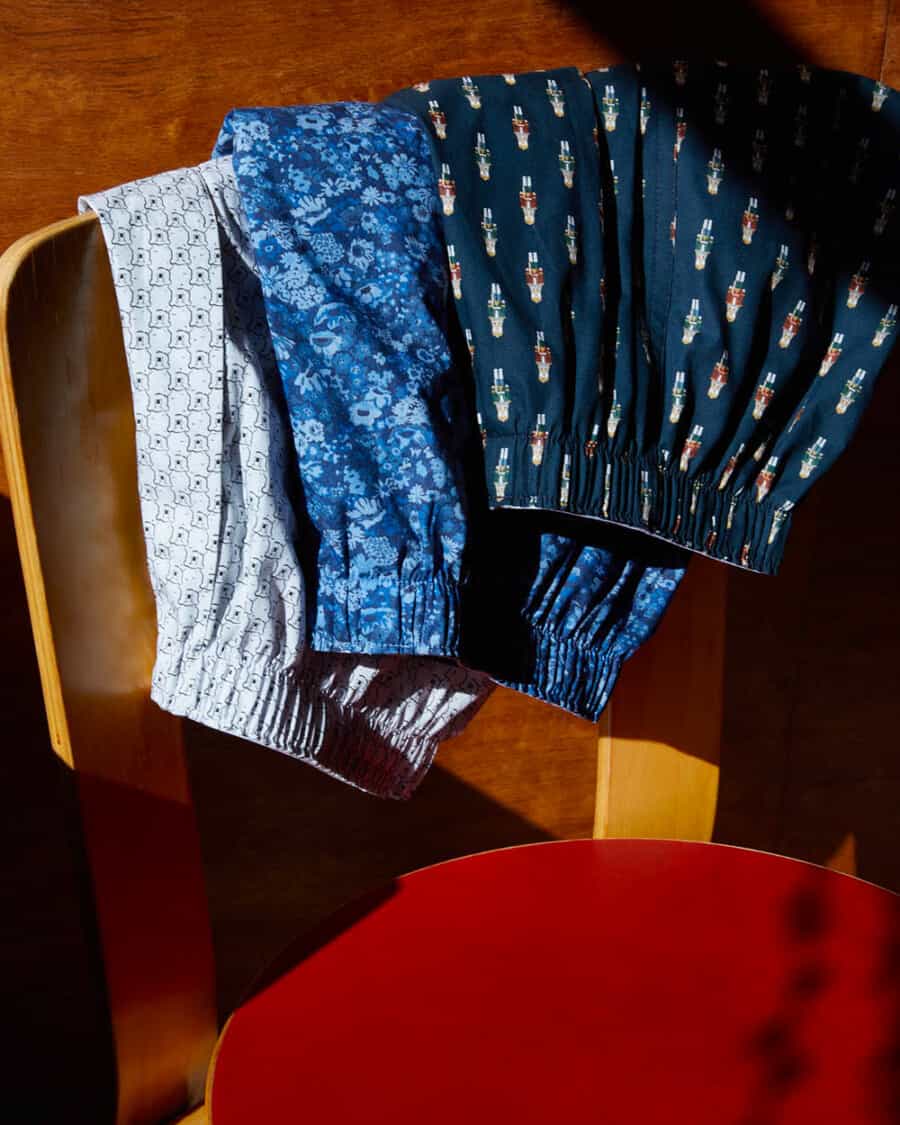 Three pairs of printed/patterned luxury men's boxer shorts over the back of a chair