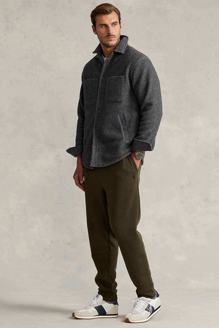 Men's dark green sweatpants, charcoal flannel overshirt and retro running sneakers outfit