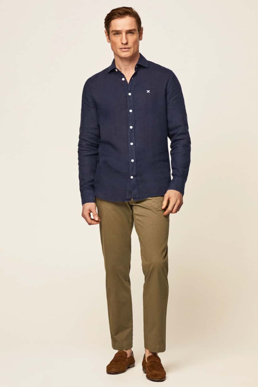 Men's khaki green pants, untucked navy shirt and brown suede penny loafers outfit