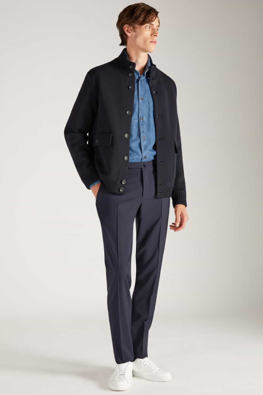 Men's navy tailored pants, blue denim shirt, navy wool bomber jacket and white sneakers outfit