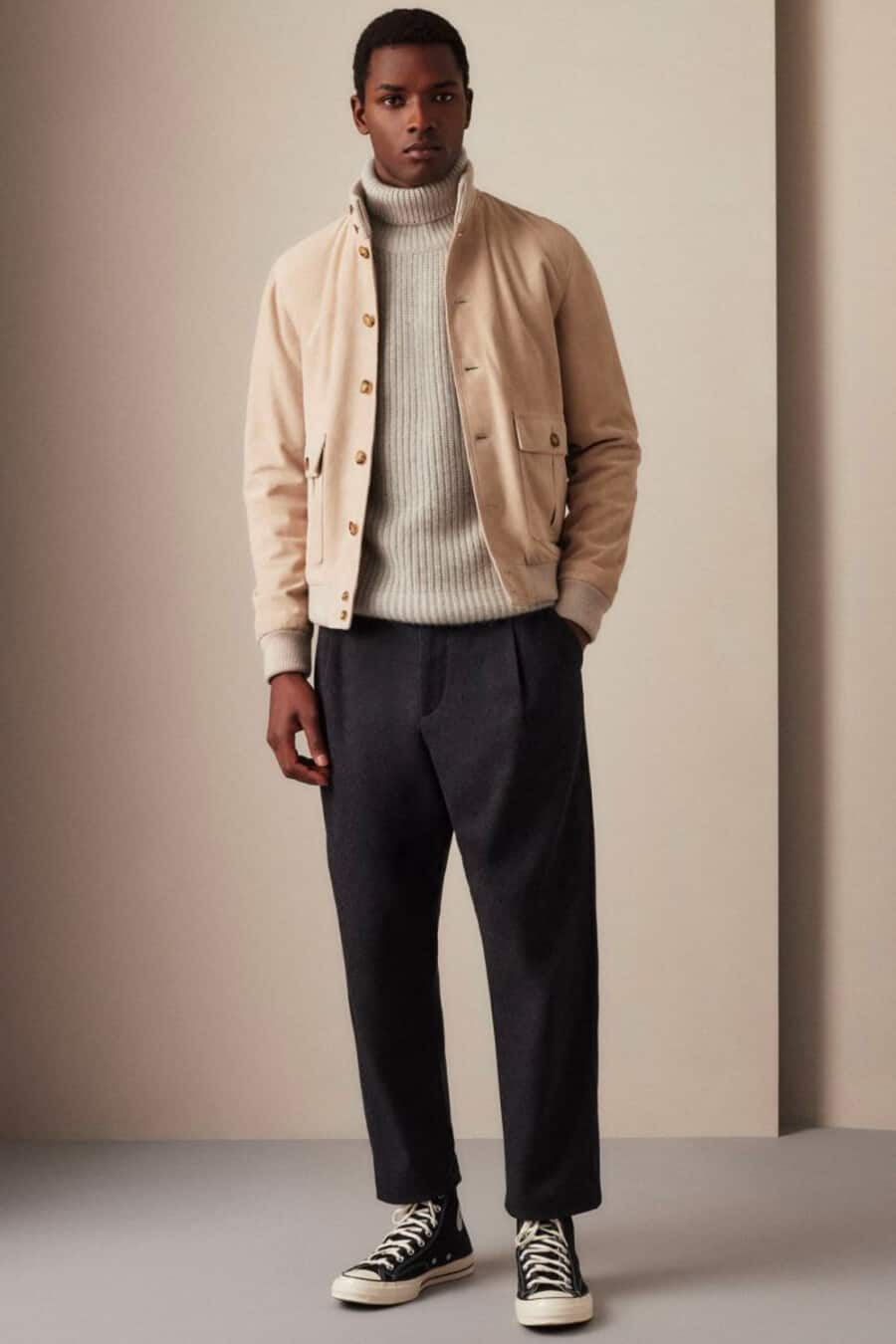 Men's cropped black pants, ribbed grey roll neck jumper, camel wool bomber jacket and black Converse high-top sneakers outfit