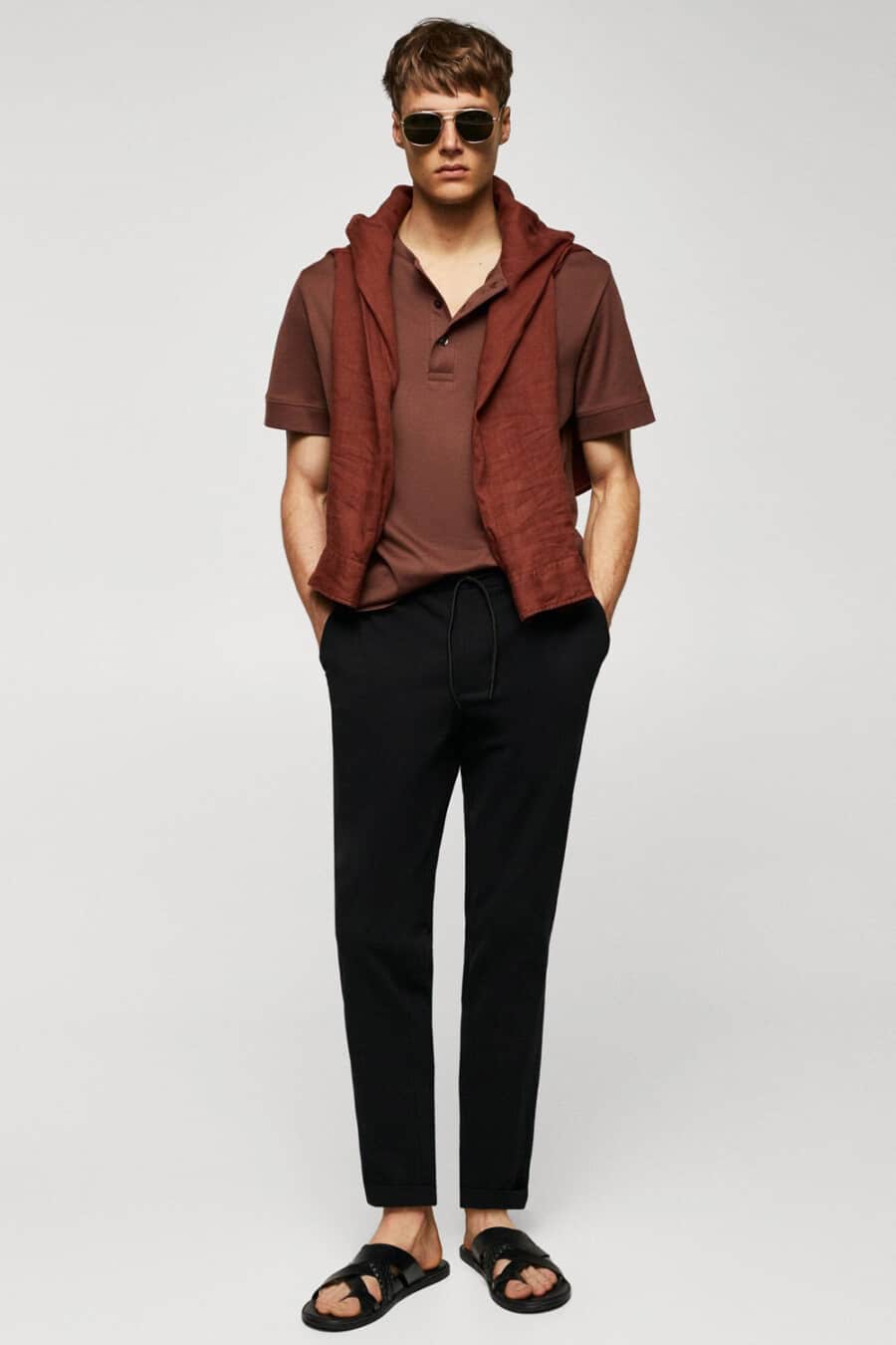 Men's black cropped pants, brown polo shirt and black sandals outfit
