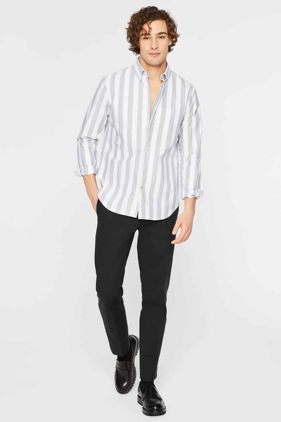 Men's black pants, white and grey vertical stripe shirt and black Derby shoes outfit
