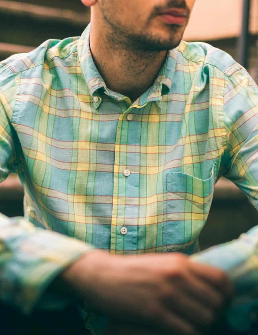 Close up of a man wearing a yellow and blue madras summer shirt