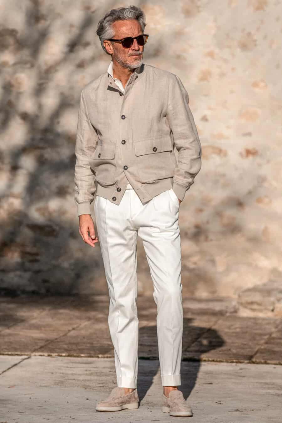 Men's white trousers, stone linen bomber jacket and suede loafers outfit