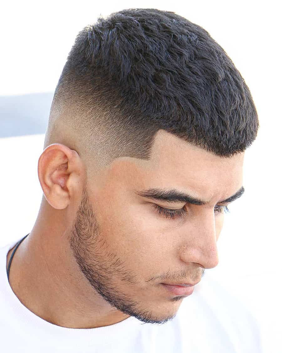 Men's thick black hair caesar cut with high taper fade