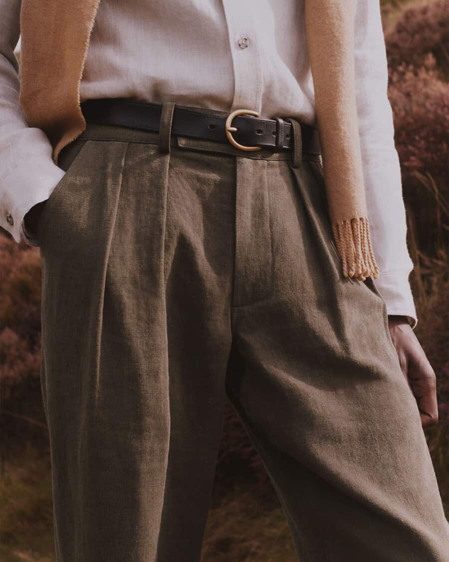 Men's pleated olive green linen trousers and white shirt