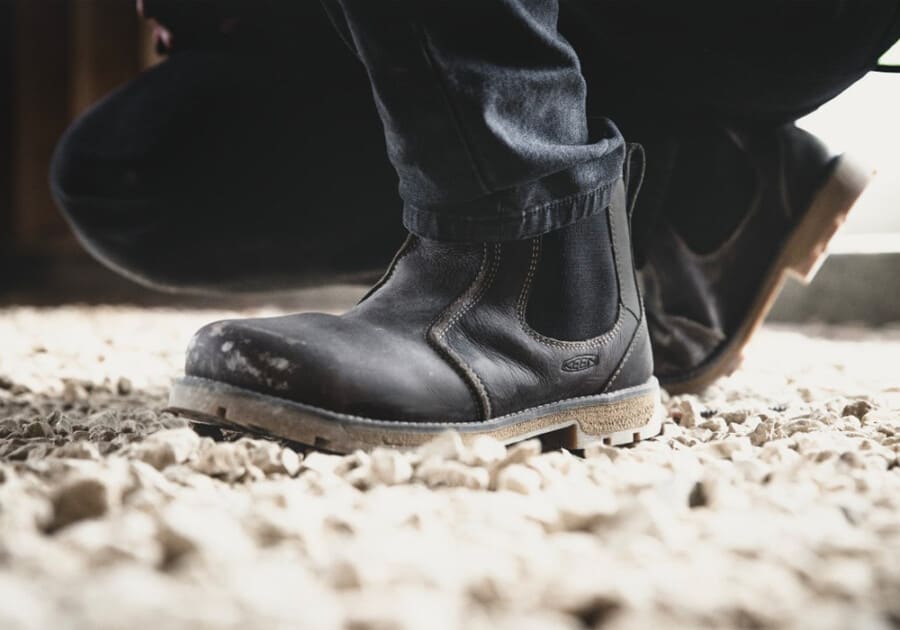 Man wearing black slip of Chelsea work boots with black work pants