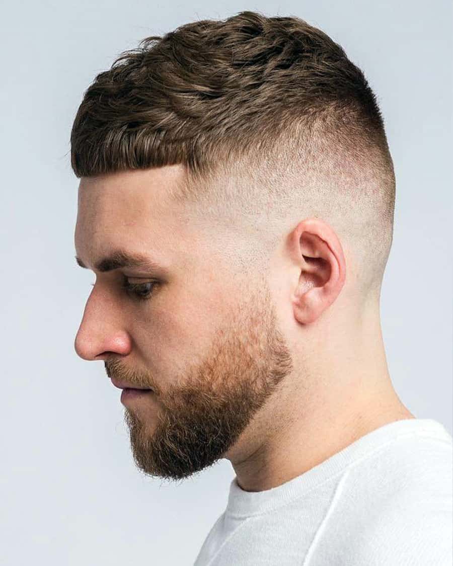 Men's modern Caesar haircut with a high bald fade