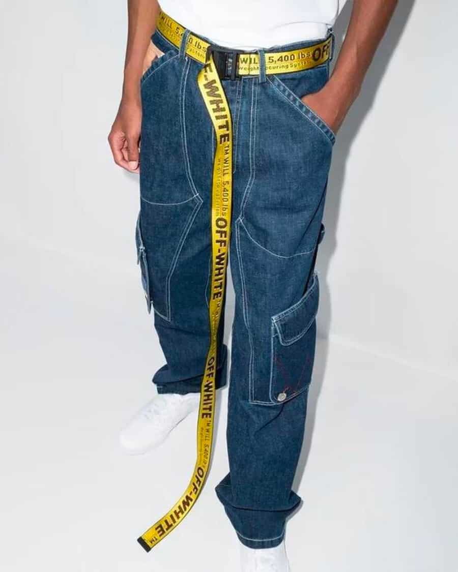 Man wearing utility jeans and long Off-White yellow tape belt