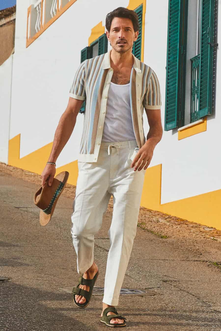 Men's white tailored pants, white vest, open short sleeve shirt and sandals outfit