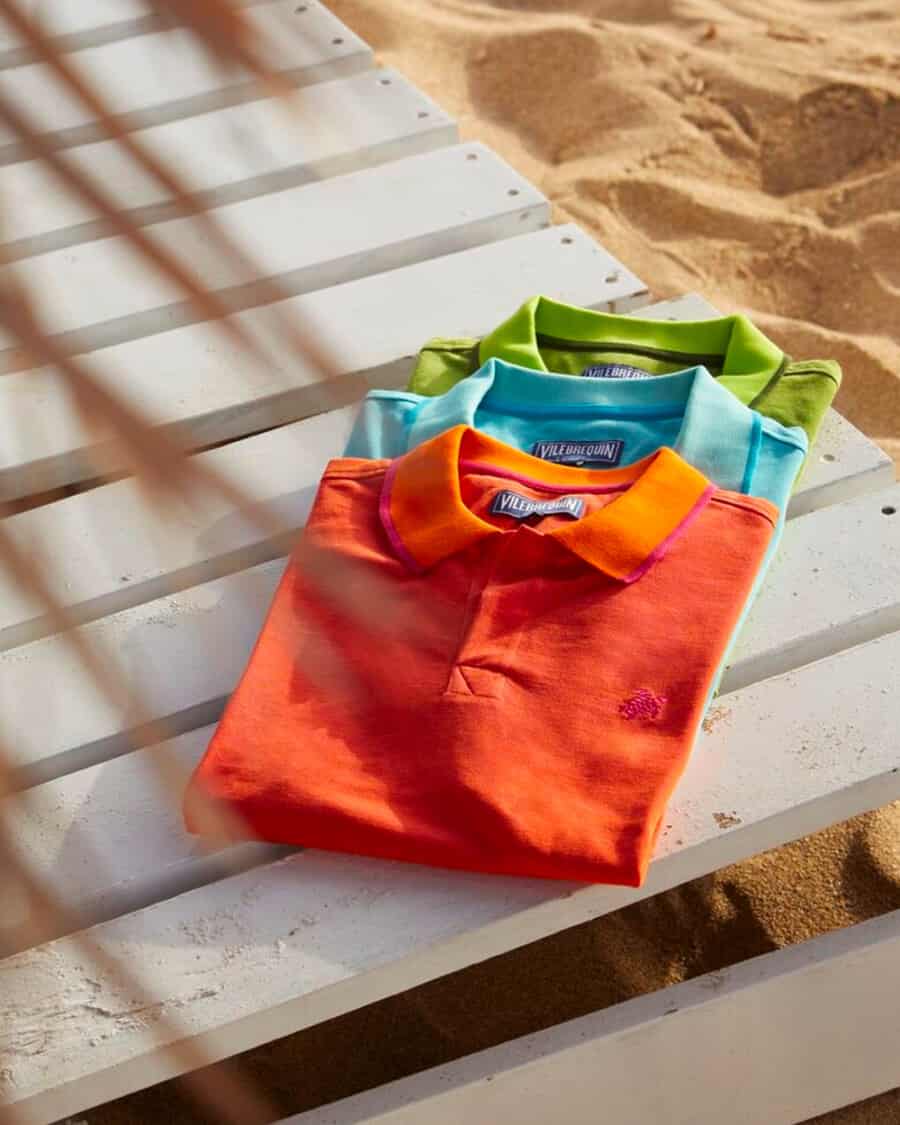 Three bright coloured luxury men's polo shirts by Vilebrequin in orange, cobalt blue and green