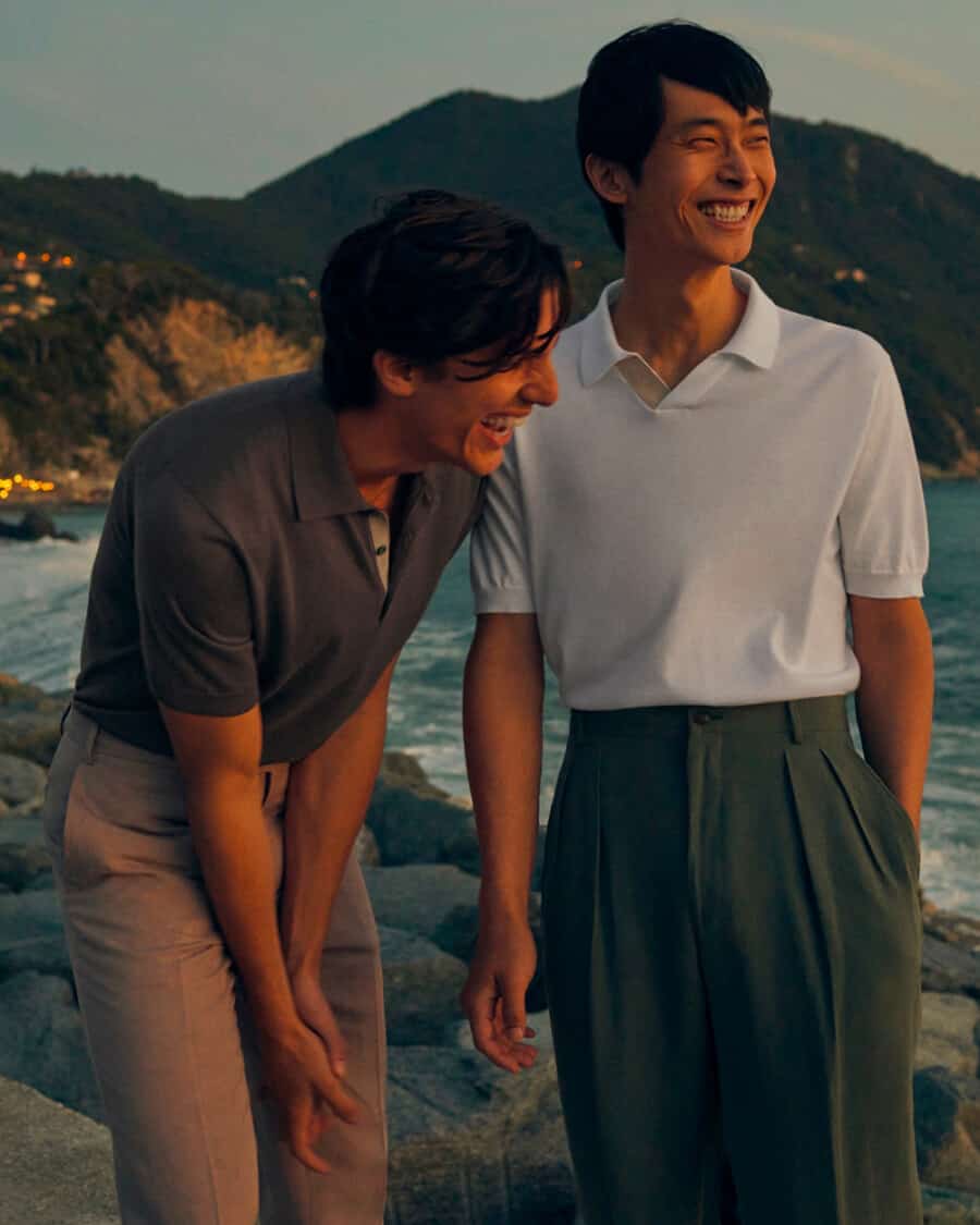 Two Asian men wearing high end Canali polo shirts tucked into pleated and flat front pants