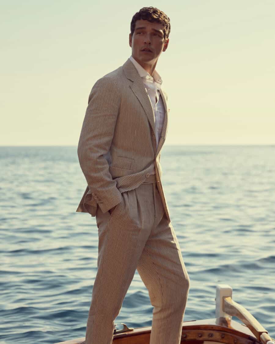 Man wearing a high quality stone Brunello Cucinelli suit with a white shirt