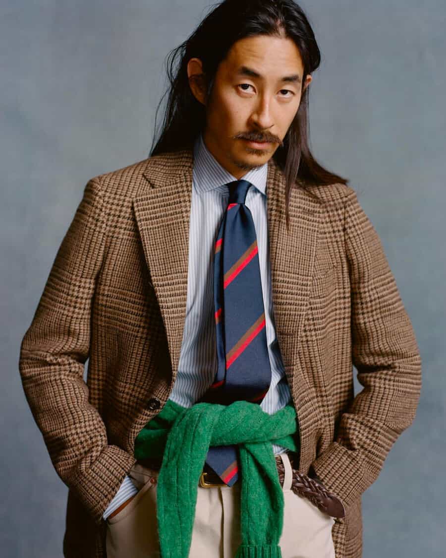 Man wearing a high quality Drake’s wool blazer, blue stripe dress shirt, club rep tie and beige chinos