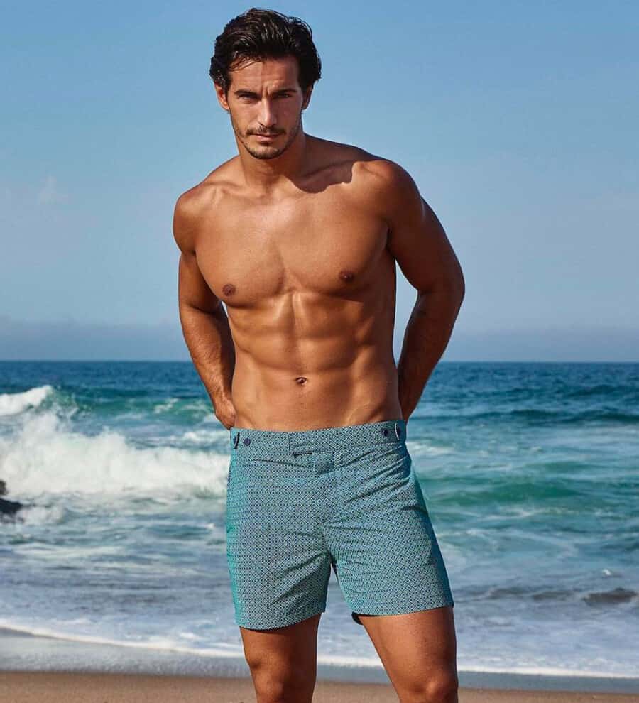 Man wearing luxury mid-blue patterned tailored swim shorts by Frescobol Carioca