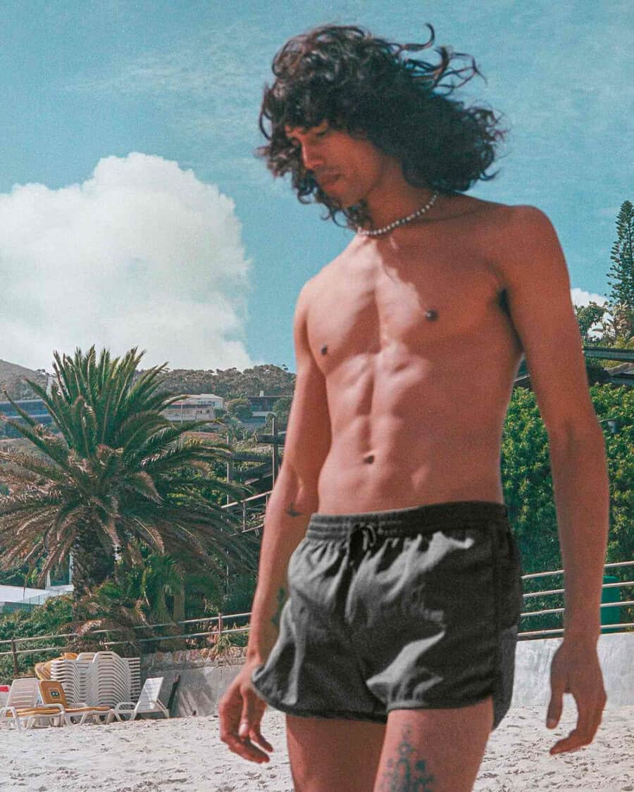 Man wearing swim shorts made of Made of Econyl, nylon fibre repurposed from landfill and ocean waste