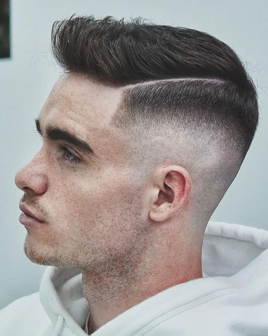 Man wearing a faux hawk haircut with high skin fade