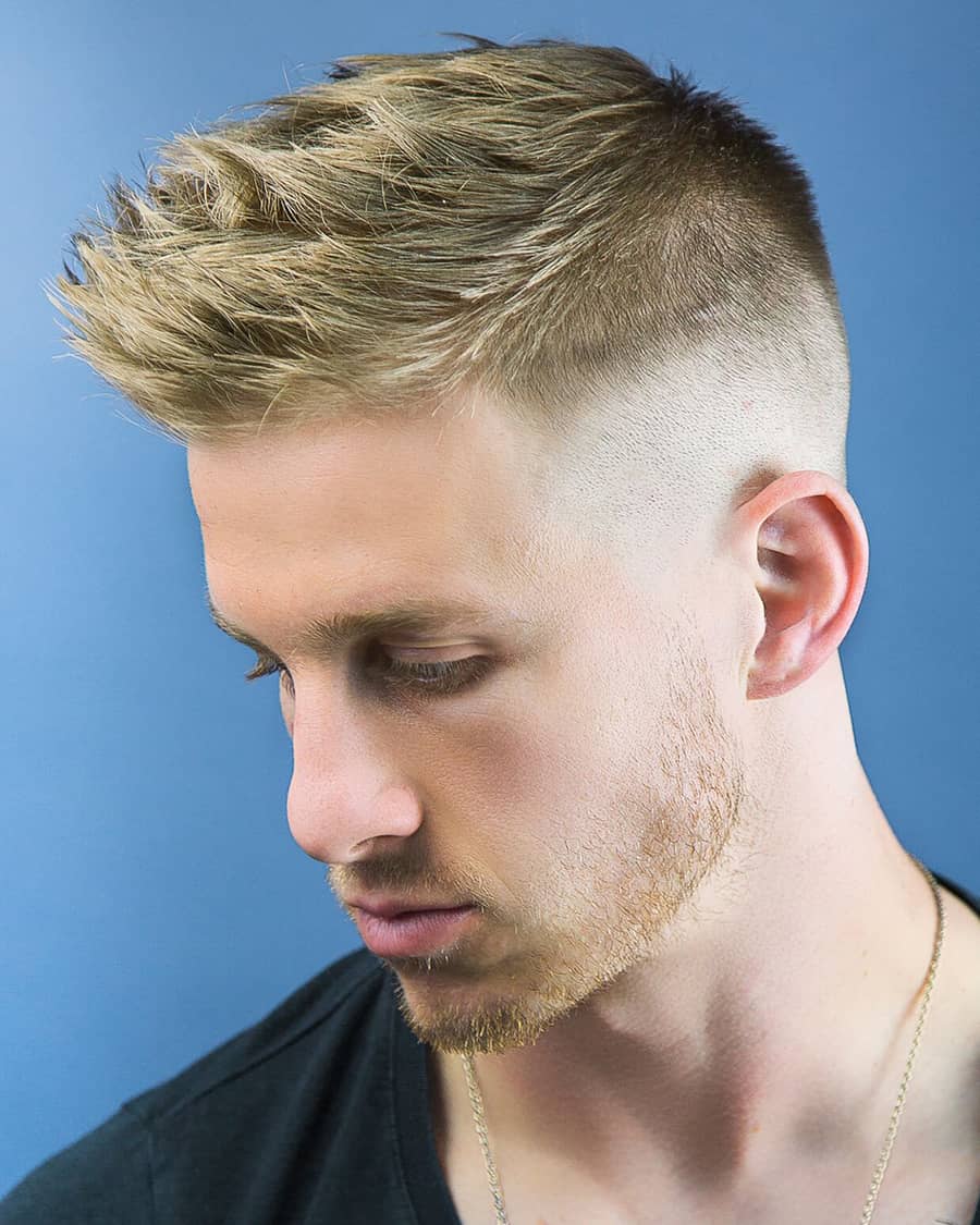 Man with a blonde high and tight faux hawk hairstyle