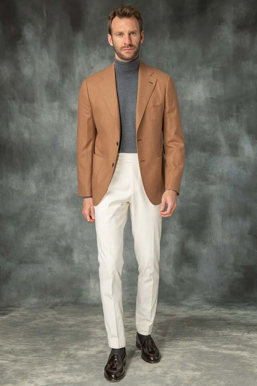 Men's cream pants, grey turtleneck sweater, tobacco blazer and brown leather tassel loafers outfit