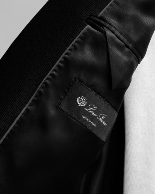 The inside label of a Loro Piana luxury black blazer