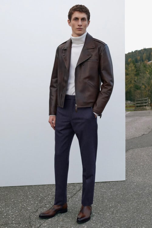 Men's navy pants, white roll neck, brown leather biker jacket and brown leather boots outfit