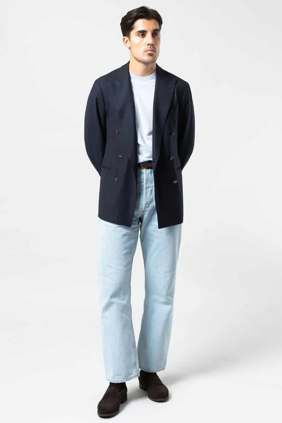 Men's light blue jeans, white T-shirt, open navy double-breasted blazer and brown suede loafers outfit
