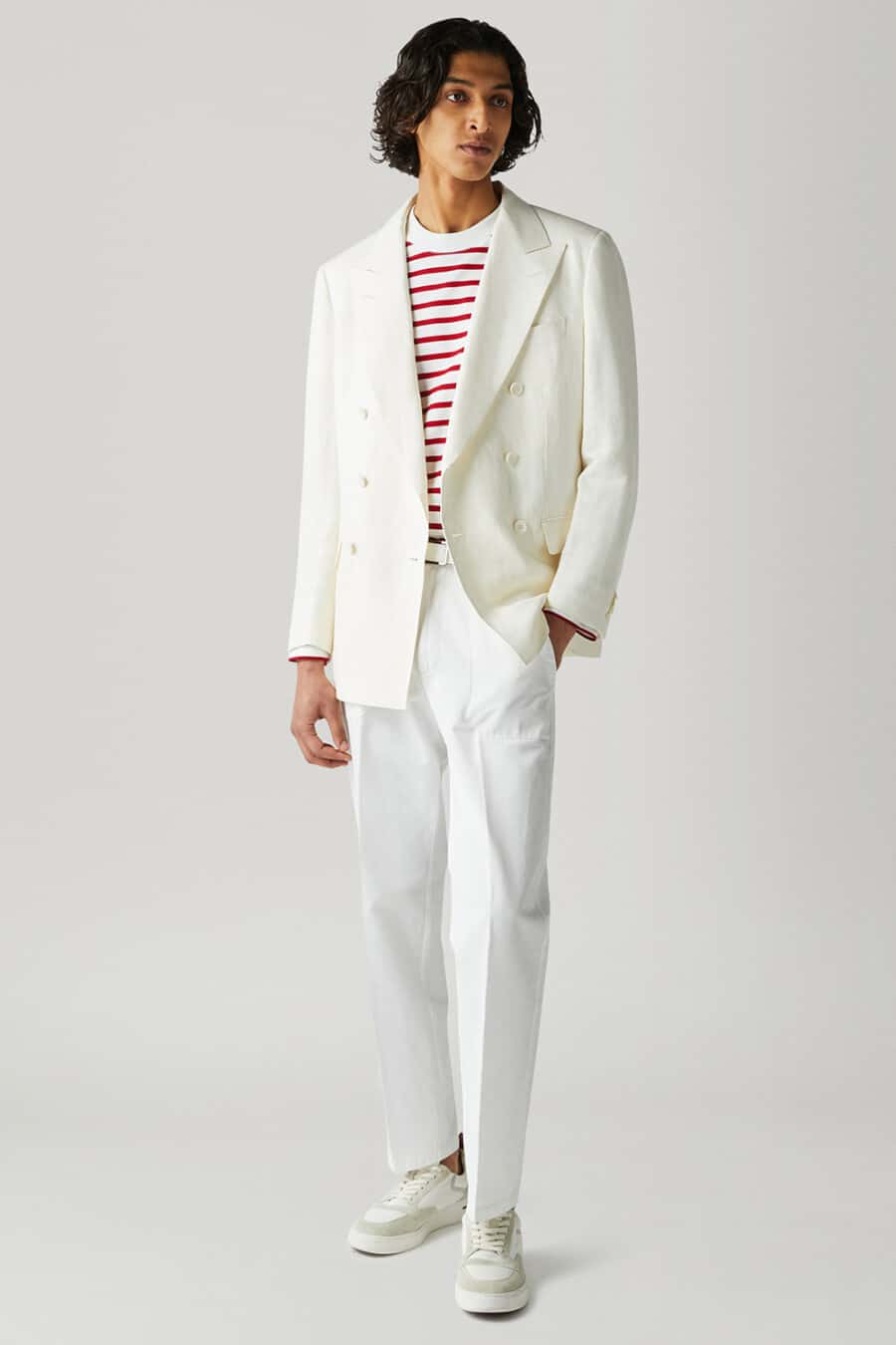 Men's white pants, white & red stripe top, cream double-breasted blazer and white sneakers outfit