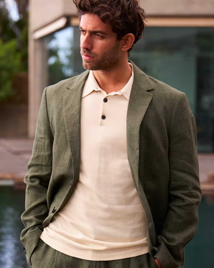 Man wearing a green unstructured suit and cream knitted polo shirt