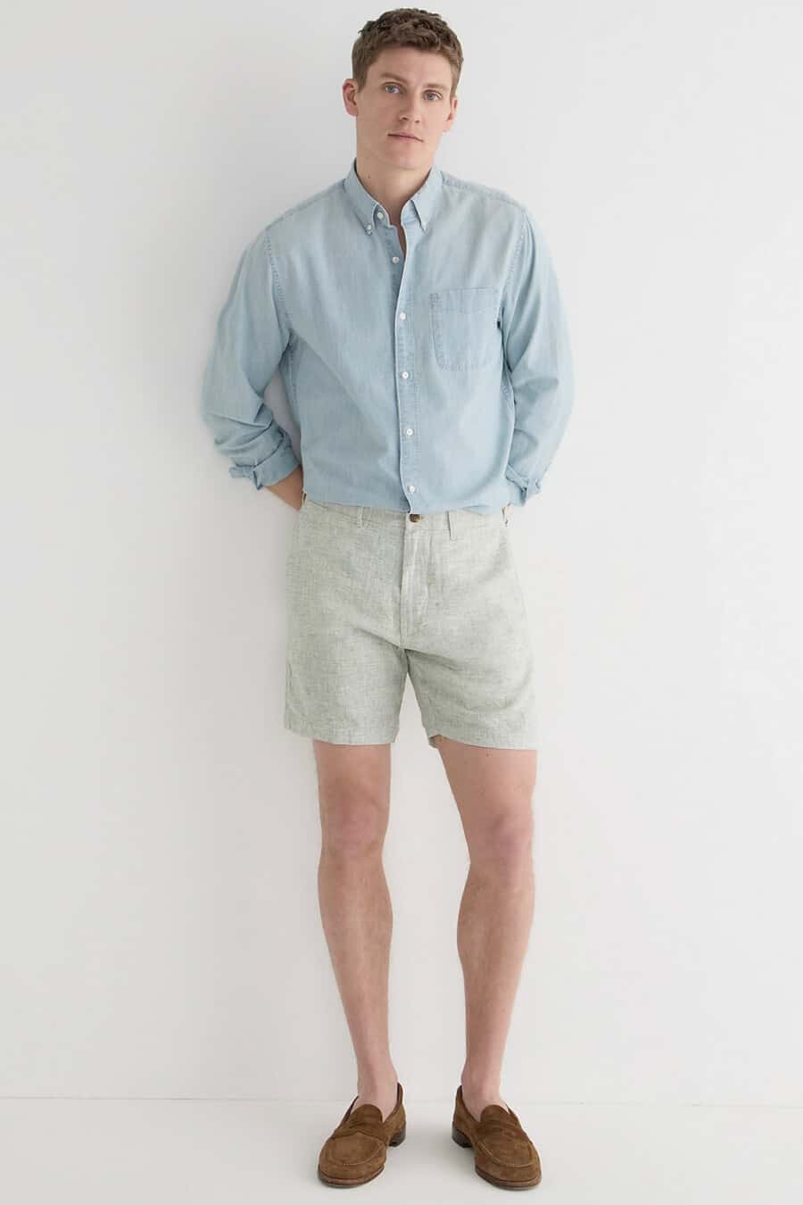 Men's light green shorts, light blue denim/chambray shirt and brown suede loafers outfit