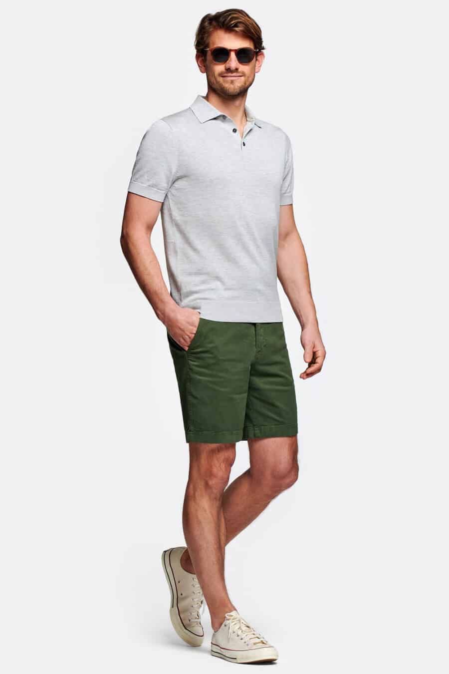Men's green shorts, light grey polo shirt and off-white canvas sneakers outfit