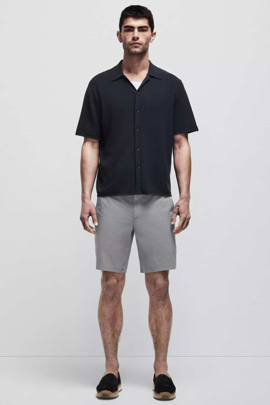 Men's grey shorts, short sleeve black shirt and black espadrilles outfit